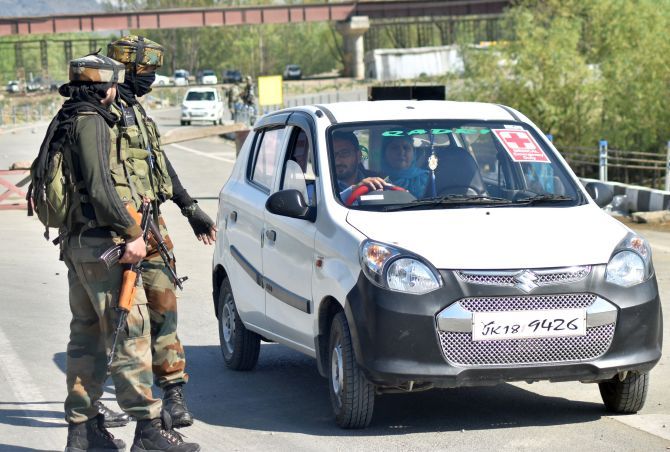Security personnel stop vehicles on the Jammu-Srinagar national highway. Photograph: Umar Ganie/Rediff.com