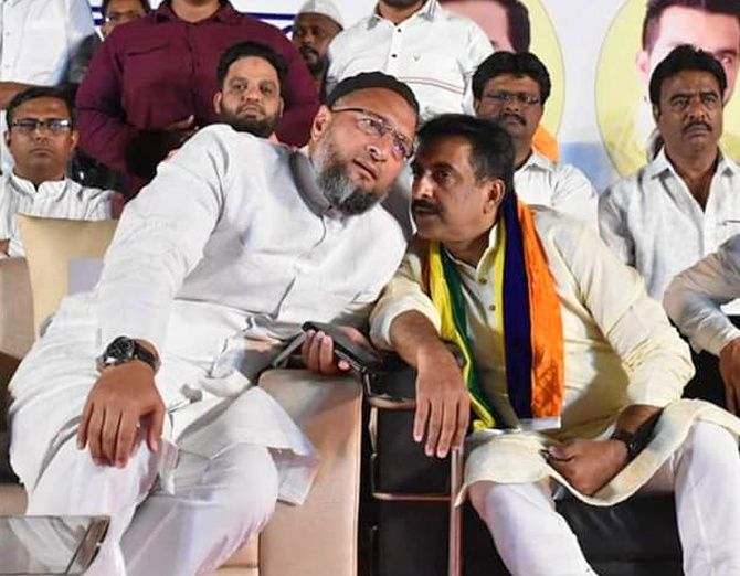 Imtiaz Jaleel, the AIMIM's candidate for the Lok Sabha election in Aurangabad, right, whispers to AIMIM President Asaduddin Owaisi.
