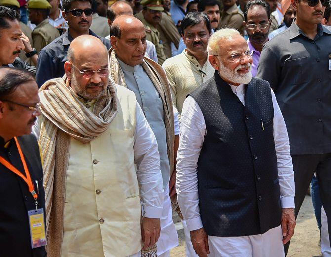 Escorted by Home Minister Rajnath Singh, centre, and Bharatiya Janata Party national President Amit Anilchandra Shah, Prime Minister Narendra Damodardas Modi walks to file his nomination to contest the Lok Sabha election in Varanasi, April 26, 2019