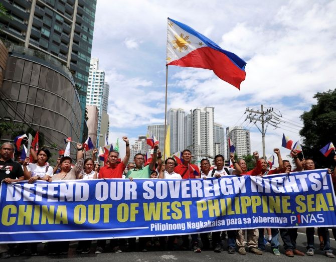 Filipino activists and opposition leaders march to protest against the presence of Chinese vessels in South China Sea at the Chinese Embassy in Makati City, Philippines, April 9, 2019