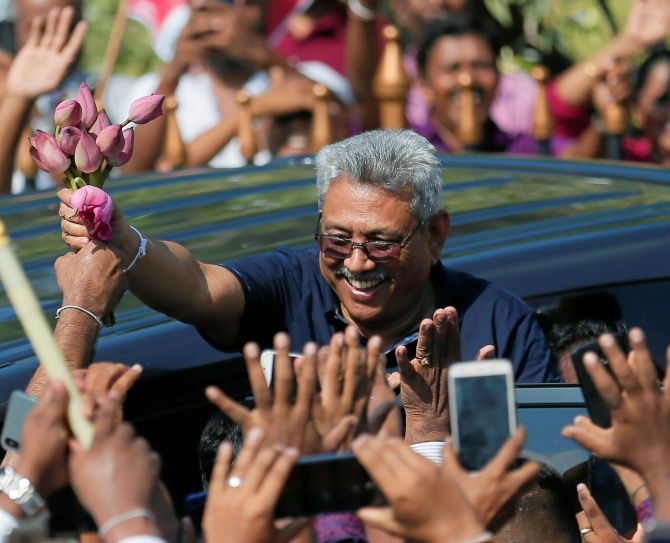Sri Lanka's former defense secretary Gotabaya Rajapaksa greets his supporters after his return from the United States