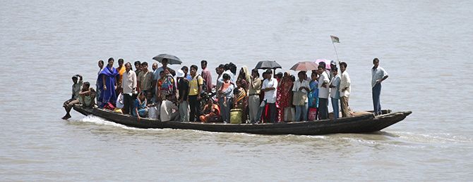 People crowd a boat on the Ichamati river at Hasnabad, West Bengal. Photograph: Parth Sanyal/Reuters.