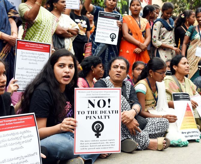 Women organisations and students hold placards during a protest demanding justice for the rape and murder of a 25-year-old veterinarian, in Hyderabad, on Sunday