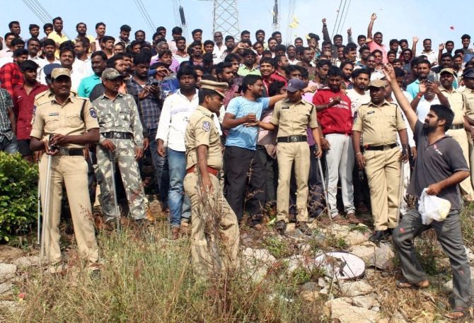 People shower flower petals and hail the police at the encounter site, where the four men accused of the gruesome rape and murder of a 25-year-old woman veterinary doctor were shot dead by the police early on December 6, 2019. Photograph: PTI Photo