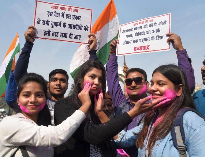 People celebrate the killing of four accused in the Hyderabad rape case