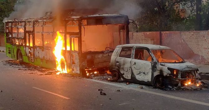 Vehicles were torched as anti-citizenship protesters clashed with police in New Delhi on Sunday