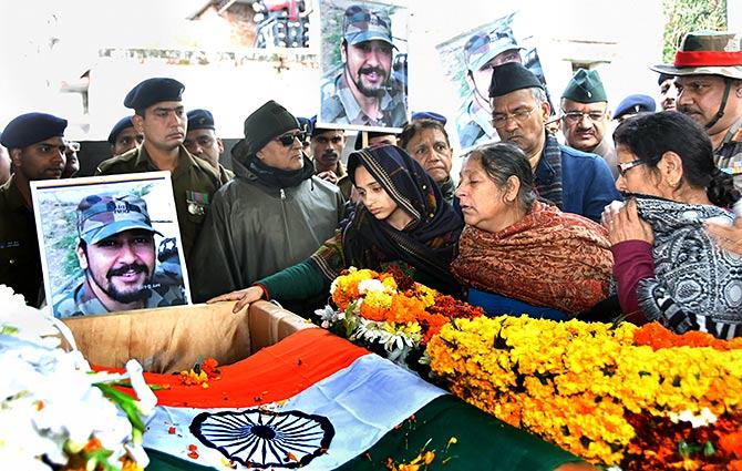 Major Vibhuti Shankar Dhaundiyal's wife Nitika Kaul and family members pay homage to the brave soldier who lost his life in the February 18 encounter with terrorists in Dehradun. Photograph: PTI Photo