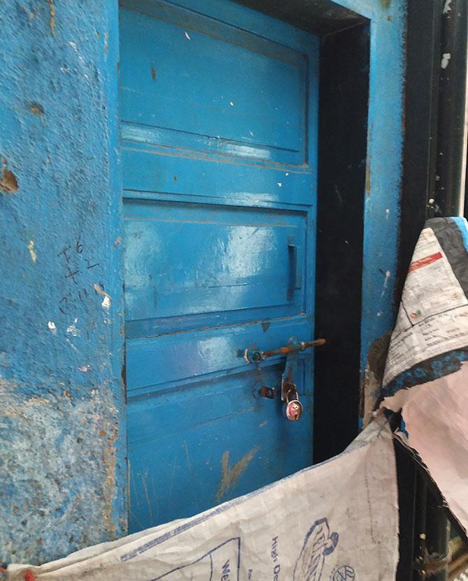 The locked blue door to the home the couple lived in.