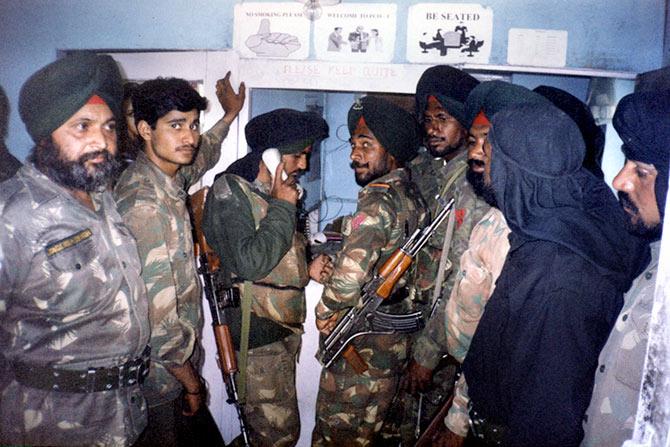 Soldiers queue up to make phone calls from a phone booth during the war.