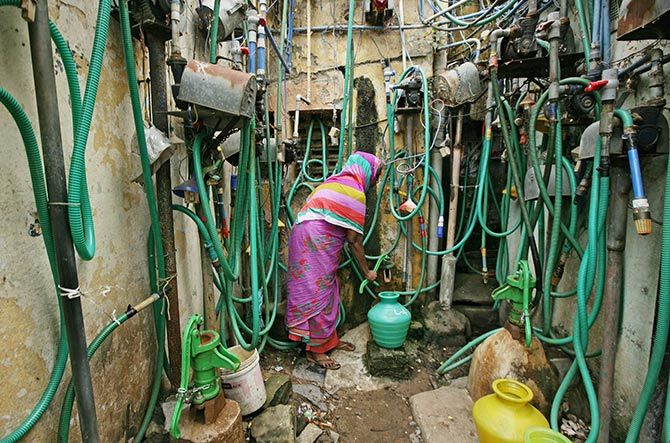  A woman uses a hand pump to fill up a container with drinking water in Chennai. Photograph: P Ravikumar/Reuters.