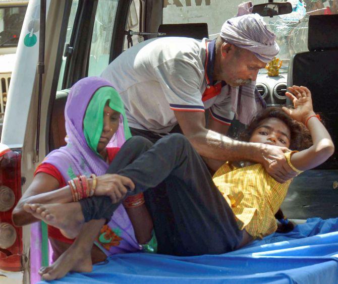 A child showing symptoms of Acute Encephalitis Syndrome arrives for treatment at a hospital in Muzaffarpur. Photograph: PTI Photo