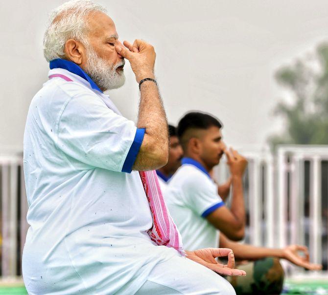 Prime Minister Narendra Modi performs an asana during a Yoga Day event