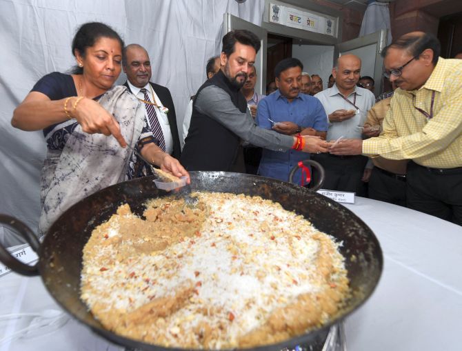 Finance Minister Nirmala Sitharaman and Minister of State for Finance Anurag Thakur at the Halwa ceremony to mark the beginning of printing of budgetary documents in New Delhi, June 22, 2019. Photograph Shahbaz Khan/PTI Photo