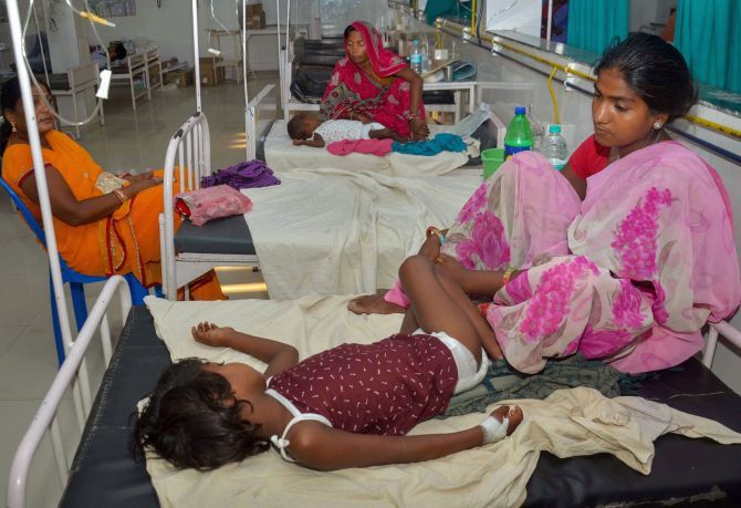 A mother sits as her child is treated for acute encephalitis syndrome at Sri Krishna Medical College and Hospital. Photograph: PTI Photo