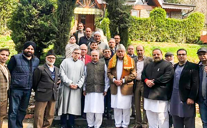 Judge Hasnain Masoodi, centre, flanked by National Conference leaders Dr Farooq Abdullah and Omar Abdullah.