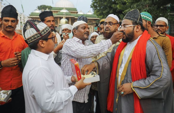 Muslims offer each other sweets after the verdict outside the Shah-e-alam shrine in Ahmedabad. Photograph: PTI Photo