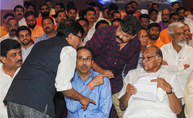 Sharad Pawar, right, and Shiv Sena President Uddhav Thackeray, centre, with Nationalist Congress Party, Congress and Shiv Sena leaders in Mumbai, November 25, 2019. Photograph: Mitesh Bhuvad/PTI Photo