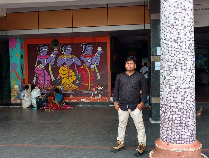On World Tourism Day last month, Visakhapatnam in Andhra Pradesh was awarded the most tourist friendly railway station in India by the central government. A man waits outside the entrance with a mural on the station wall behind him. Photographs: Rediff.com