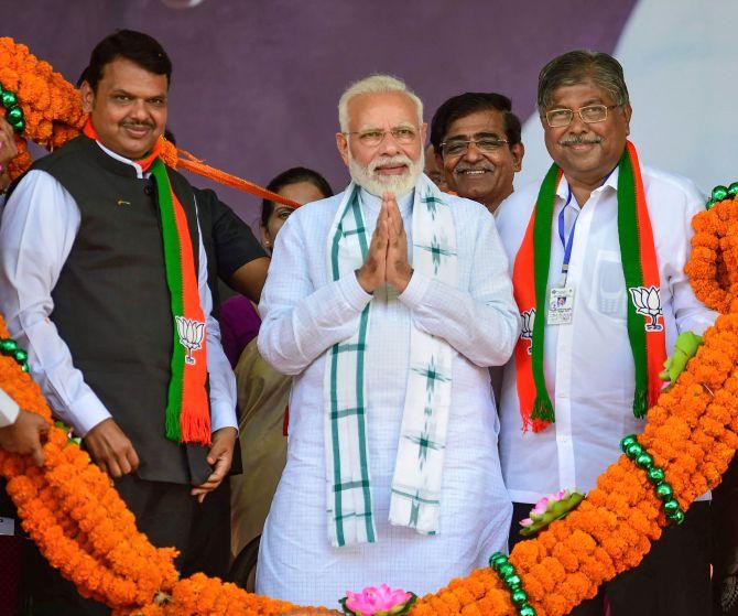 Prime Minister Narendra Damodardas Modi flanked by then Maharashtra chief minister Devendra Fadnavis, left, and the Bharatiya Janata Party's Maharashtra president Chandrakant Patil in Nashik. Photograph: Photograph: Shashank Parade/PTI Photo