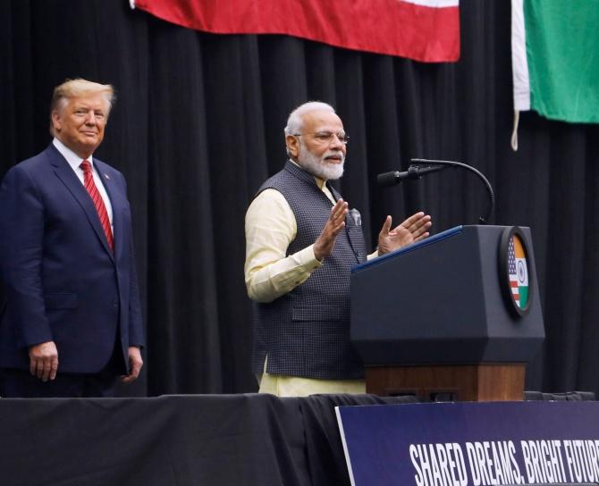 U.S. President Donald Trump looks on as Indian Prime Minister Narendra Modi speaks during a Howdy, Modi rally