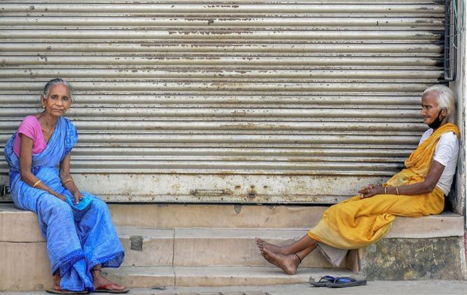 Homeless women sit outside a closed shop in Guwahati, April 7, 2020. Photograph: PTI Photo