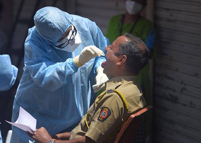 A doctor= examines a policeman at a medical camp in the Sewri slums, south central Mumbai, Wednesday, April 8, 2020. Photograph: Shashank Parade/PTI Photo