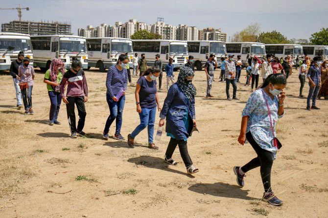 Gujarat students from Kota maintain a physical distance after they arrive in Ahmedabad, April 23, 2020. Photograph: PTI Photo