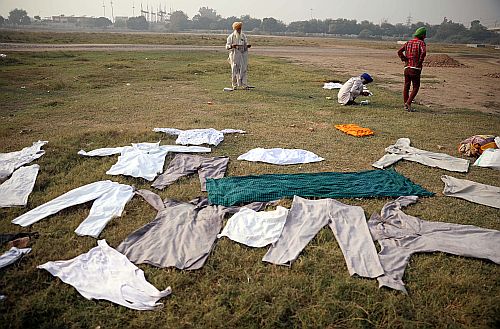 Farmers dry their clothes at the Nirankari ground in Delhi