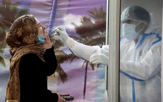 A health worker collects a nasal swab sample for a Rapid Antigen test for COVID-19 in Srinagar, December 20, 2020. Photograph: Imran Nissar/ANI Photo