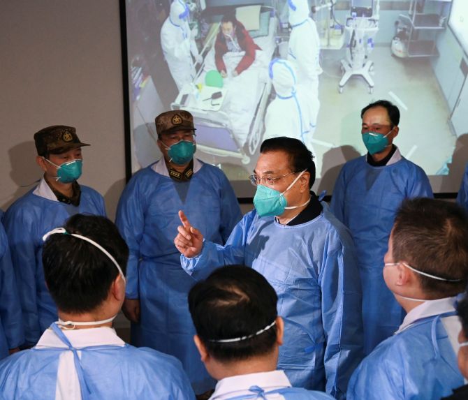 Chinese Premier Li Keqiang wearing a mask and a protective suit speaks to medical workers at the Jinyintan hospital in Wuhan, where patients with coronavirus were being treated. Photograph: cnsphoto via Reuters