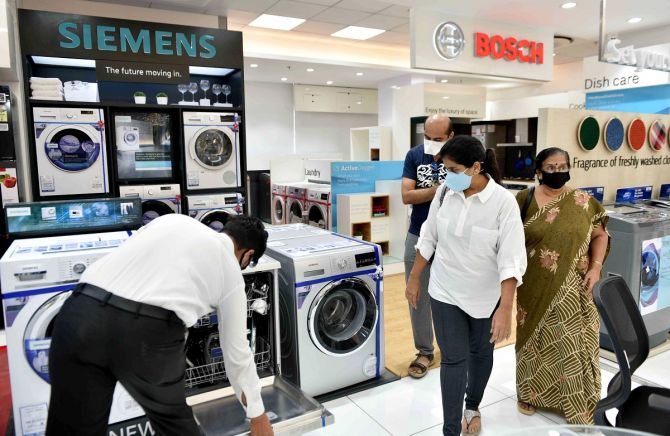Customers look for electronic appliances at a kohinoor electronic showroom. Photograph: ANI Photos