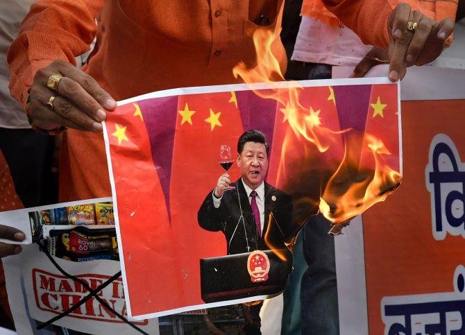 VHP and Bajrang Dal activists burn a poster of Chinese President Xi Jinping in Bhopal after 20 soldiers were killed during the face-off between Indian and Chinese troops in Ladakh. Photograph: PTI Photo