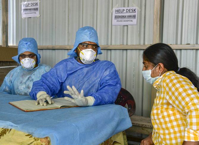 A lady who recently returned from the United States being examined by doctors at a coronavirus help desk at a Hyderabad hospital. Photograph: PTI Photo