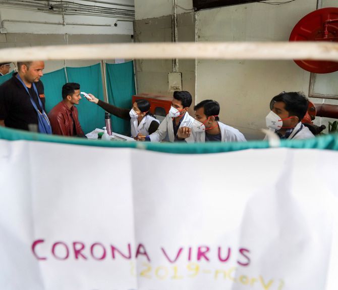 Doctors screen patients for coronavirus at a government hospital in New Delhi. Photograph: PTI Photo