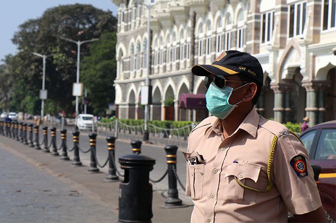 A cop is seen wearing mask as a precaution at Gateway of India