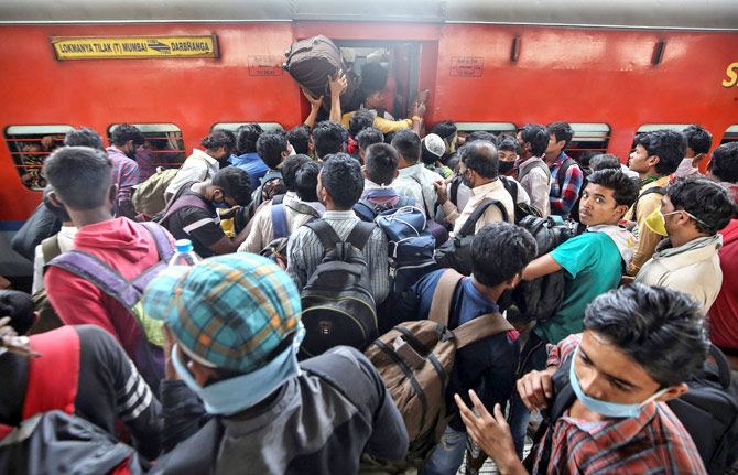 Migrant workers and their families board an overcrowded passenger train, after the Maharashtra government imposed restrictions on public gatherings in attempts to prevent the spread of coronavirus in Mumbai, March 21, 2020. Photograph: Prashant Waydande/Reuters