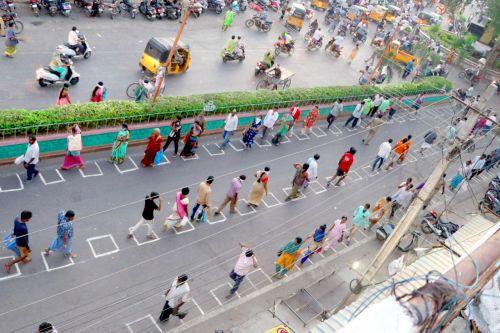 People at a vegetable market follow social distancing