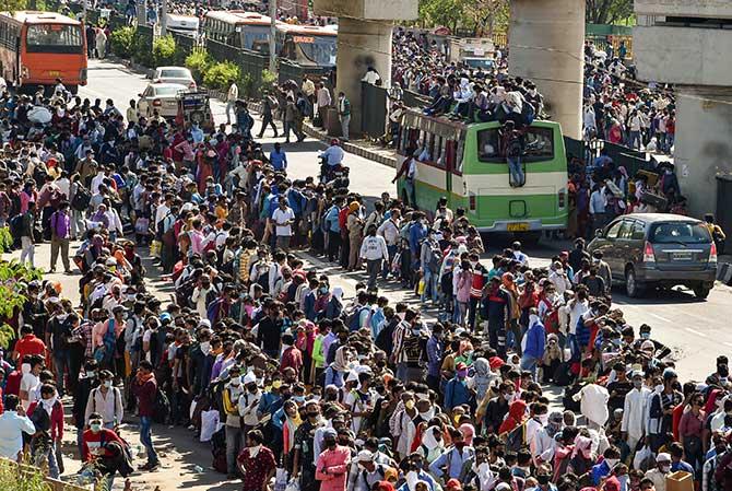 Indians wait to board a bus to their villages at Kaushambi in Ghaziabad, March 28, 2020. Photograph: Manvender Vashist/PTI Photo