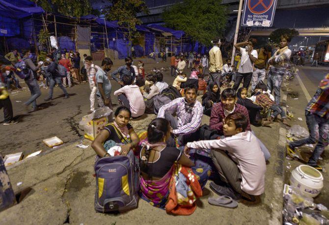 Indians wait for a bus to take them to their villages, March 28, 2020. Photograph: Vijay Verma/PTI Photo