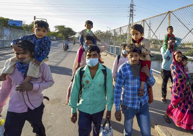 Migrant workers and their families walk to their native village during a nationwide lockdown at Kalyanpuri in East Delhi. Photograph: Manvender Vashist/PTI Photo
