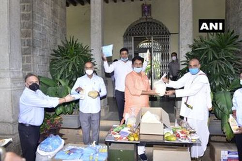 Officials distribute food, masks & hand sanitizers among the needy in Bengaluru.