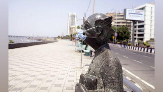 RK Laxman's Common Man wears a mask at Worli Seaface