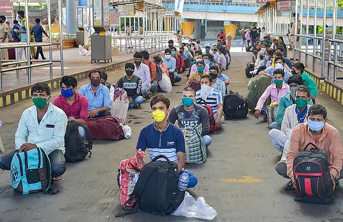 On May 7, migrants wait at Thane railway station to board a special train to Patna.