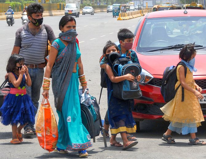 A migrant family look for buses to reach a railway station as they travel towards their native place.