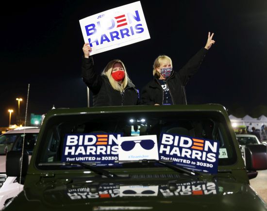 Supporters attend a drive-in election night event for Democratic presidential nominee Joe Biden at the Chase Center in Wilmington, Delaware