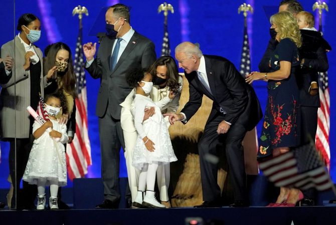 Kamala Harris introduces her grand niece to Joe Biden  at their election rally in Wilmington, Delaware. Photograph: Andrew Harnik/Reuters