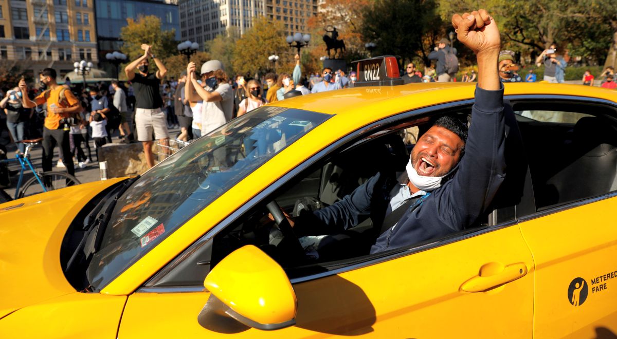 A New York cabbie celebrates Joe Biden's victory at Union Square, New York City. Photograph: Andrew Kelly/Reuters