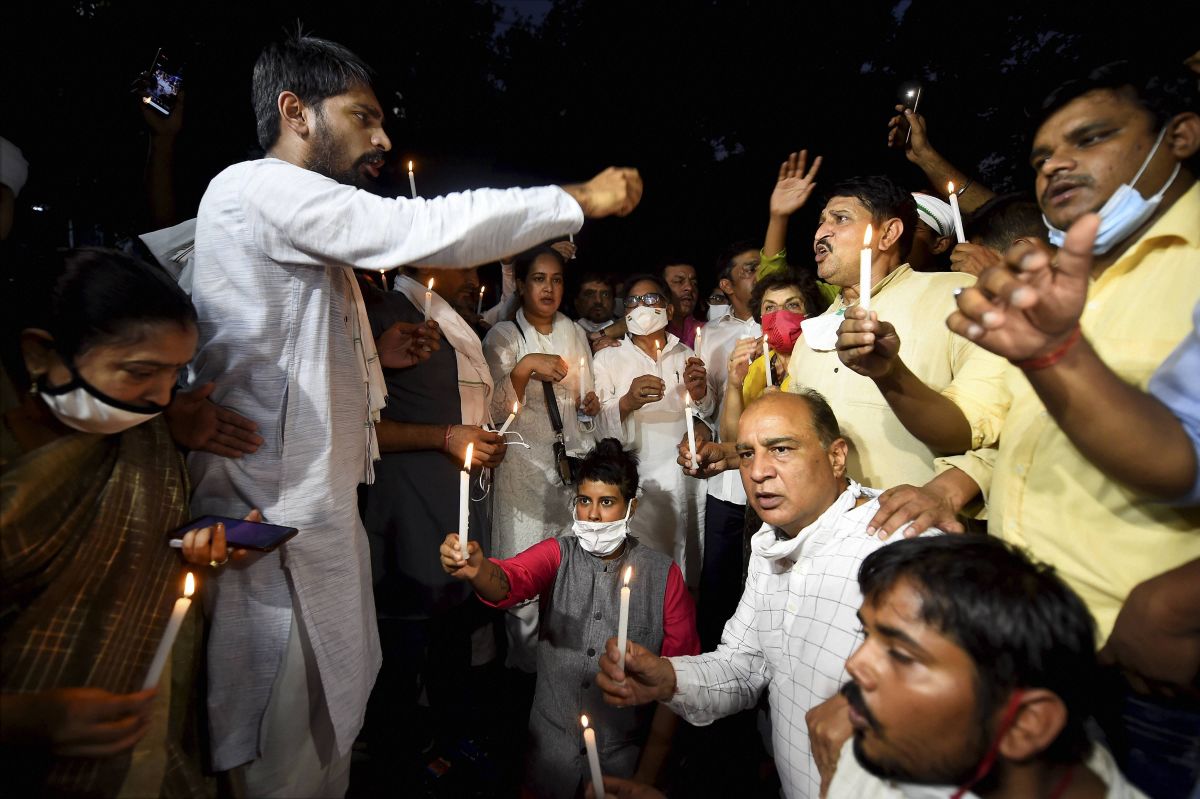 Congress activists participate in a candle light protest over the death of the Hathras gangrape victim, at Safdarjung hospital in New Delhi