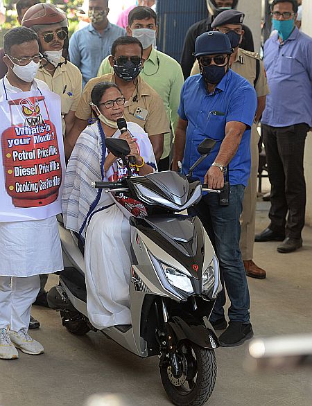 Mamata sits astride an electric scooter at Nabanna