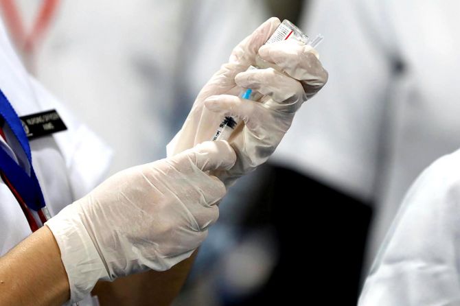A healthcare worker fills a syringe with a dose of Bharat Biotech's COVID-19 vaccine Covaxin at the All India Institute of Medical Sciences in New Delhi, January 16, 2021. Photograph: Adnan Abidi/Reuters